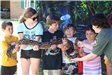 Children holding a snake