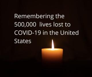 lit candle on a black backdrop, with white text that says "remembering the 500,000 lives lost to COVID-19 in the United States"