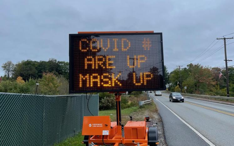 An image of the DPW LED signboard, placed on route 12, that reads "COVID #s are up - mask up"